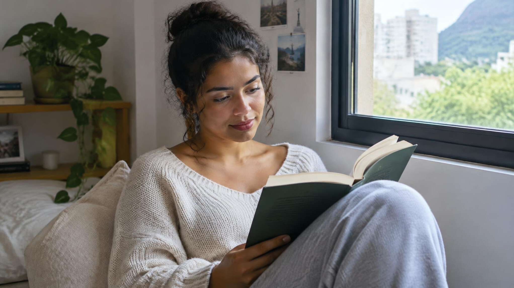 Person reading a book in a calm, bright space